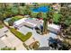 Stunning aerial view of luxury home with pool, putting green, tennis court, and water view in Scottsdale, Arizona at 87 Biltmore Est, Phoenix, AZ 85016