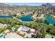 Beautiful aerial view of a home near a golf course with a pool, tennis court, and lush landscaping at 87 Biltmore Est, Phoenix, AZ 85016