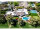 Aerial view of luxury home's backyard oasis: pool, tennis court, putting green, and beautiful landscaping in Scottsdale at 87 Biltmore Est, Phoenix, AZ 85016