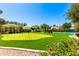 Backyard putting green and pickleball court under a blue sky with landscaping at 87 Biltmore Est, Phoenix, AZ 85016