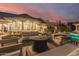 Expansive backyard patio with comfortable seating around a fire pit, perfect for outdoor entertaining near the pool at 87 Biltmore Est, Phoenix, AZ 85016