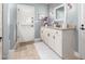 Charming bathroom with a shaker-style vanity, neutral countertop, and a door to the outside at 87 Biltmore Est, Phoenix, AZ 85016