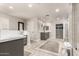 This bathroom features a zero-entry shower, dual vanities, and expansive countertops at 87 Biltmore Est, Phoenix, AZ 85016