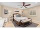 This bedroom features a wicker frame, ceiling fan, neutral decor and an accent rug at 87 Biltmore Est, Phoenix, AZ 85016