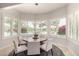 Charming breakfast nook with bay windows offering views of the pool and landscaped yard at 87 Biltmore Est, Phoenix, AZ 85016