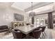 Formal dining room with elegant lighting, a large table, and access to outdoor space at 87 Biltmore Est, Phoenix, AZ 85016