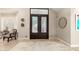 Bright and airy foyer with iron doors, tile flooring, and neutral walls, offering a clean and modern aesthetic at 87 Biltmore Est, Phoenix, AZ 85016