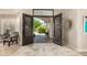Welcoming foyer with decorative iron doors, tile flooring, and stylish decor, creating an elegant entrance at 87 Biltmore Est, Phoenix, AZ 85016