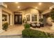 Inviting front porch featuring decorative iron door, bay window, columns, and comfortable seating in Scottsdale, Arizona at 87 Biltmore Est, Phoenix, AZ 85016