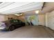 Well-maintained garage with epoxy floors, storage cabinets, and a Tesla parked inside at 87 Biltmore Est, Phoenix, AZ 85016