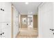 Bright hallway with tiled floors, white built-in storage, and a decorative mirror leading to other rooms at 87 Biltmore Est, Phoenix, AZ 85016