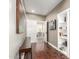 Interior hallway featuring hardwood floors, neutral paint, decorative art, and view of an open living area at 87 Biltmore Est, Phoenix, AZ 85016