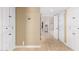 Hallway with tiled floors and white cabinets, offering ample storage space at 87 Biltmore Est, Phoenix, AZ 85016