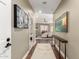 Interior hallway featuring hardwood floors, neutral paint, and decorative art leading to the living area at 87 Biltmore Est, Phoenix, AZ 85016