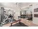 Spacious home gym equipped with exercise machines, mirrored wall, and bright lighting at 87 Biltmore Est, Phoenix, AZ 85016