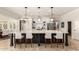Spacious kitchen with a large island, modern light fixtures, stainless steel appliances, and tiled flooring at 87 Biltmore Est, Phoenix, AZ 85016