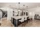 Open concept kitchen featuring a large island with marble countertops, and views of adjacent living area at 87 Biltmore Est, Phoenix, AZ 85016