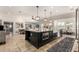 Open kitchen featuring a large island with granite countertops, stainless steel appliances, and modern lighting at 87 Biltmore Est, Phoenix, AZ 85016