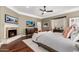 Main bedroom with hardwood floors, fireplace, ceiling fan, and plenty of natural light at 87 Biltmore Est, Phoenix, AZ 85016