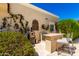 Outdoor kitchen with built-in grill and bar seating perfect for al fresco dining and entertaining at 87 Biltmore Est, Phoenix, AZ 85016