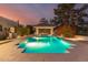 A luxurious backyard pool and hot tub, with elegant landscaping and ambient lighting for evening enjoyment at 87 Biltmore Est, Phoenix, AZ 85016
