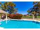 Stunning pool view showcasing a covered gazebo, landscaping, and pristine blue water at 87 Biltmore Est, Phoenix, AZ 85016