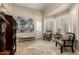 Bright sitting area with high ceilings, decorative art, shuttered windows, and tile flooring at 87 Biltmore Est, Phoenix, AZ 85016