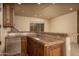 Entertainment bar with a sink, granite countertop, and cabinets with stainless steel refrigerator at 8925 E Ann Way, Scottsdale, AZ 85260