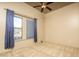 Neutral bedroom featuring a ceiling fan, blue drapes covering the windows, and neutral carpeting at 8925 E Ann Way, Scottsdale, AZ 85260