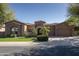 Charming stone-accented home featuring a well-manicured lawn, beautiful entry, and a two-car garage at 8925 E Ann Way, Scottsdale, AZ 85260