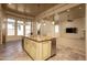 Open kitchen with custom cabinetry, large island, stainless steel appliances, and travertine flooring at 8925 E Ann Way, Scottsdale, AZ 85260