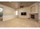 Spacious living room with cozy fireplace, a ceiling fan, neutral carpet and abundant natural light at 8925 E Ann Way, Scottsdale, AZ 85260