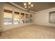 Spacious living room features multiple windows providing ample natural light and neutral carpet at 8925 E Ann Way, Scottsdale, AZ 85260