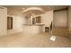 Spacious living room with carpet, neutral walls, bar with granite counters, and a staircase to the upper floor at 8925 E Ann Way, Scottsdale, AZ 85260