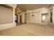 Living room area features large decorative columns, carpet flooring, and views of the front exterior at 8925 E Ann Way, Scottsdale, AZ 85260