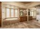 Main bathroom with double sinks, soaking tub, and large mirrors at 8925 E Ann Way, Scottsdale, AZ 85260