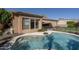 A sparkling pool with a baja shelf adjoins the home at 8925 E Ann Way, Scottsdale, AZ 85260