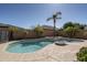 Backyard pool area with palm trees, stone accents, and clear blue water at 8925 E Ann Way, Scottsdale, AZ 85260