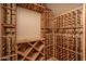 Wine cellar featuring custom built-in shelving and space for many bottles of wine at 8925 E Ann Way, Scottsdale, AZ 85260
