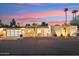 Contemporary home featuring a multi-car garage and stucco exterior complemented by desert landscaping at sunset at 9052 N 29Th St, Phoenix, AZ 85028