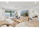 Comfortable living room with a large sectional sofa, modern coffee table, and access to the backyard at 9052 N 29Th St, Phoenix, AZ 85028