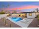 An inviting backyard boasts a sparkling pool, desert landscaping, and an outdoor seating area perfect for relaxation at 9052 N 29Th St, Phoenix, AZ 85028
