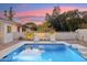 Refreshing pool with modern design and relaxing lounge chairs, set against a backdrop of lush greenery and a privacy wall at 9052 N 29Th St, Phoenix, AZ 85028