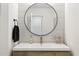 Stylish powder room with a round mirror, modern fixtures, and a wood-paneled accent wall at 9052 N 29Th St, Phoenix, AZ 85028