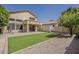 Spacious backyard with artificial turf, gravel accents, and covered patio area at 927 W Azalea Pl, Chandler, AZ 85248