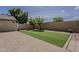 Large backyard with artificial turf, brick pavers, mature trees, and privacy wall at 927 W Azalea Pl, Chandler, AZ 85248