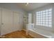 Bathroom with a soaking tub, glass-enclosed shower, closet and wood flooring at 927 W Azalea Pl, Chandler, AZ 85248