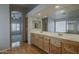 Bright bathroom boasting a double vanity and natural light, with wood flooring at 927 W Azalea Pl, Chandler, AZ 85248