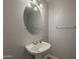 Powder room featuring a pedestal sink and a decorative mirror and lighting at 927 W Azalea Pl, Chandler, AZ 85248