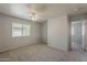 A bright bedroom with ceiling fan and a large window, offering a view of the outside at 927 W Azalea Pl, Chandler, AZ 85248